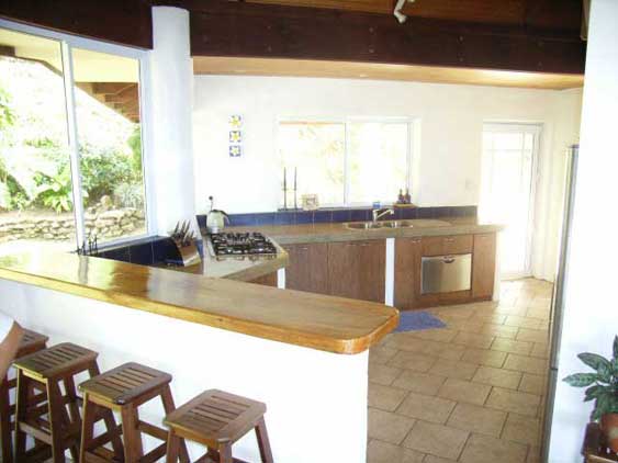 The modern kitchen off the main living room ensures the chef is not left out of conversation