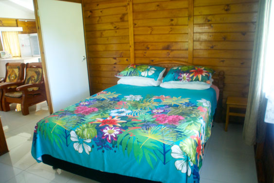 master bedroom with queen size bed at MAcs Shack