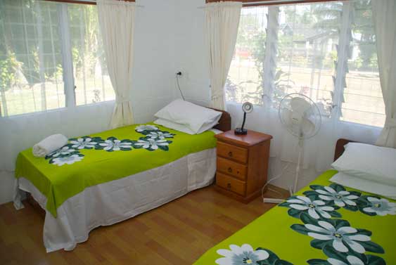 fouth bedroom with two single beds at Muri Beach Haven in Muri