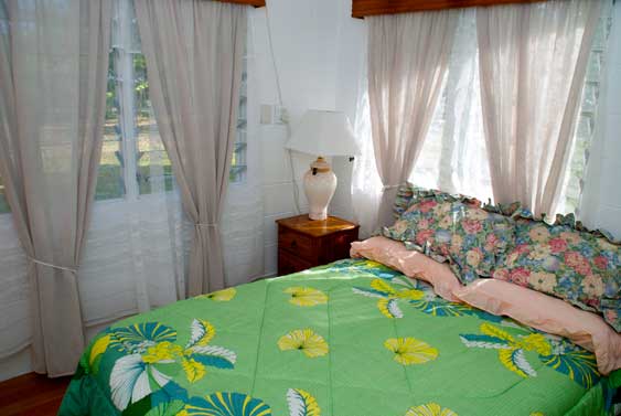 third bedroom at Muri Beach Haven, with queen size bed and tivaevae quilt