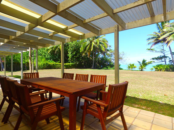 The living area extends to the patio with doors opening up to garden furniture and a bbq