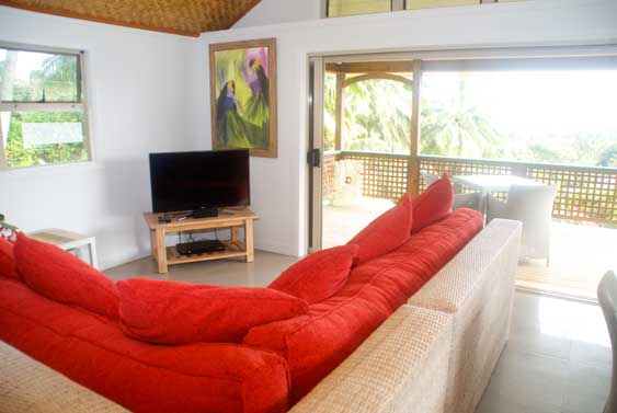 Through the sliding verandah doors, the home opens up into a spacious well lit living and dining area