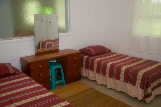 The second bedroom has two single beds
