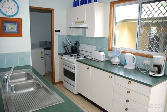 modern kitchen with full stove, dishwasher, fridge/freezer, microwave, coffee maker is well stocked with all the kitchenware 