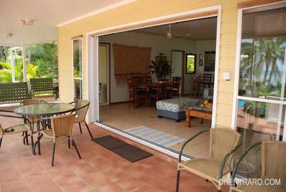 a wide shady wraparound veranda with massive sliding doors