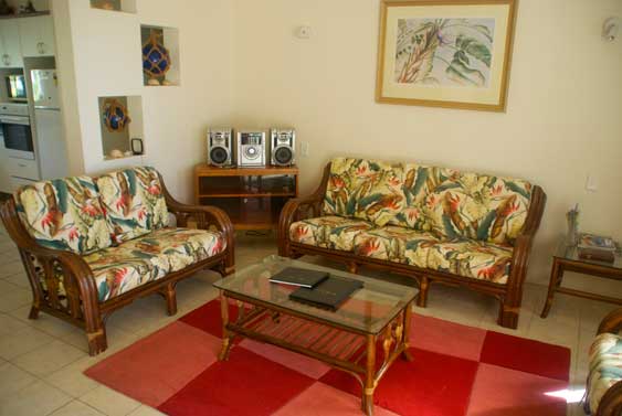 generous living area with settee, chairs, and stereo